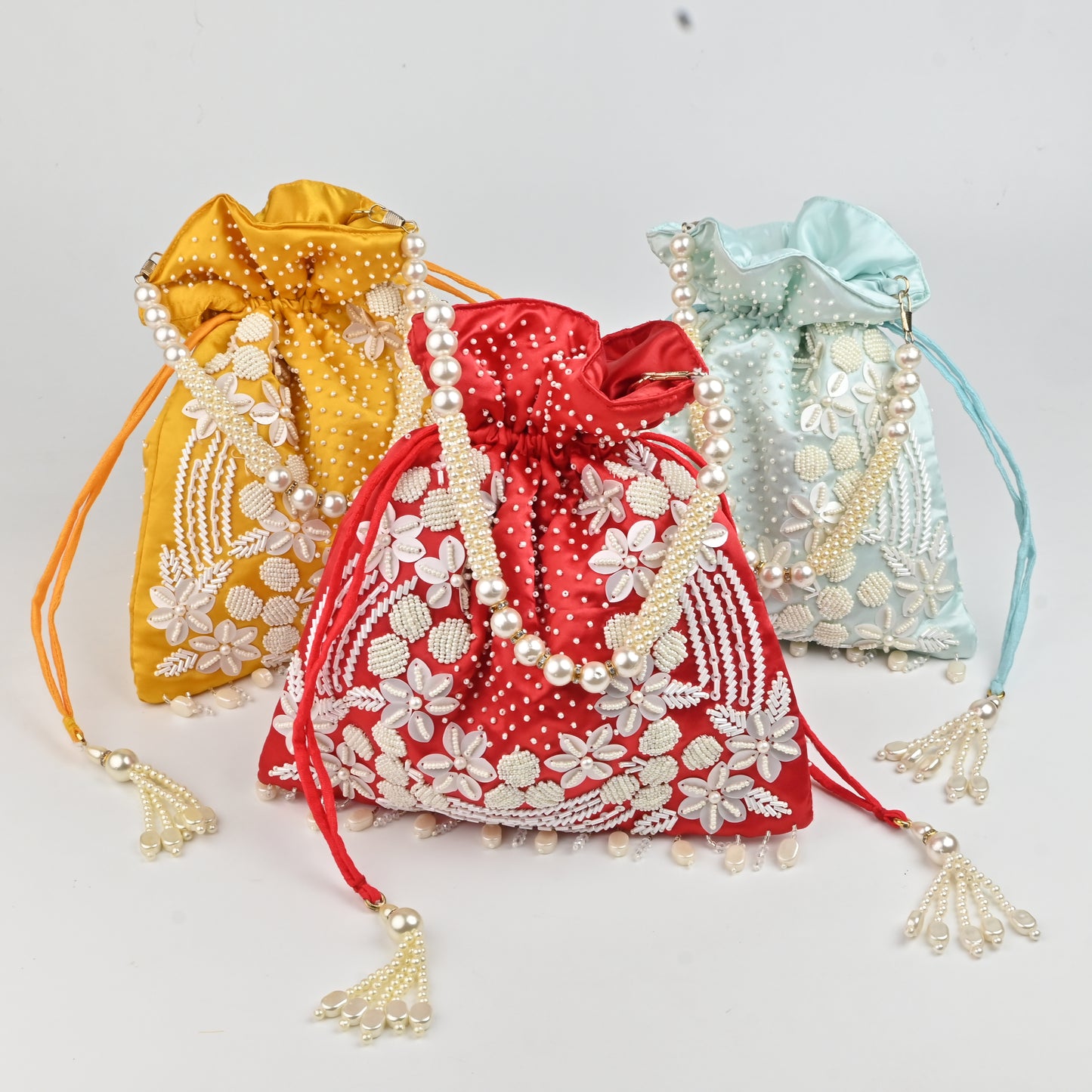 Banaavat Essence Muslin Silk Potli – White Bead & Pearl Embellished (Pastel Blue, Red & Yellow)