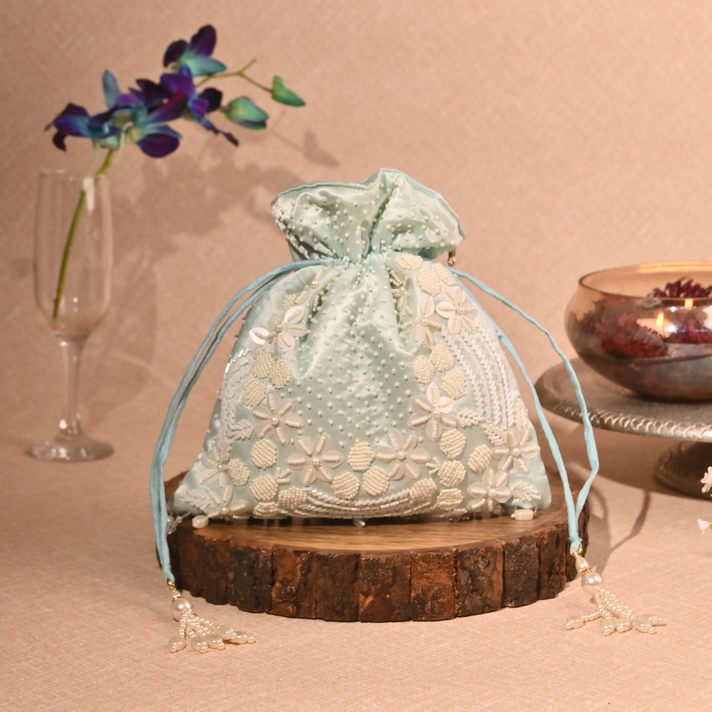 Banaavat Essence Muslin Silk Potli – White Bead & Pearl Embellished (Pastel Blue, Red & Yellow)