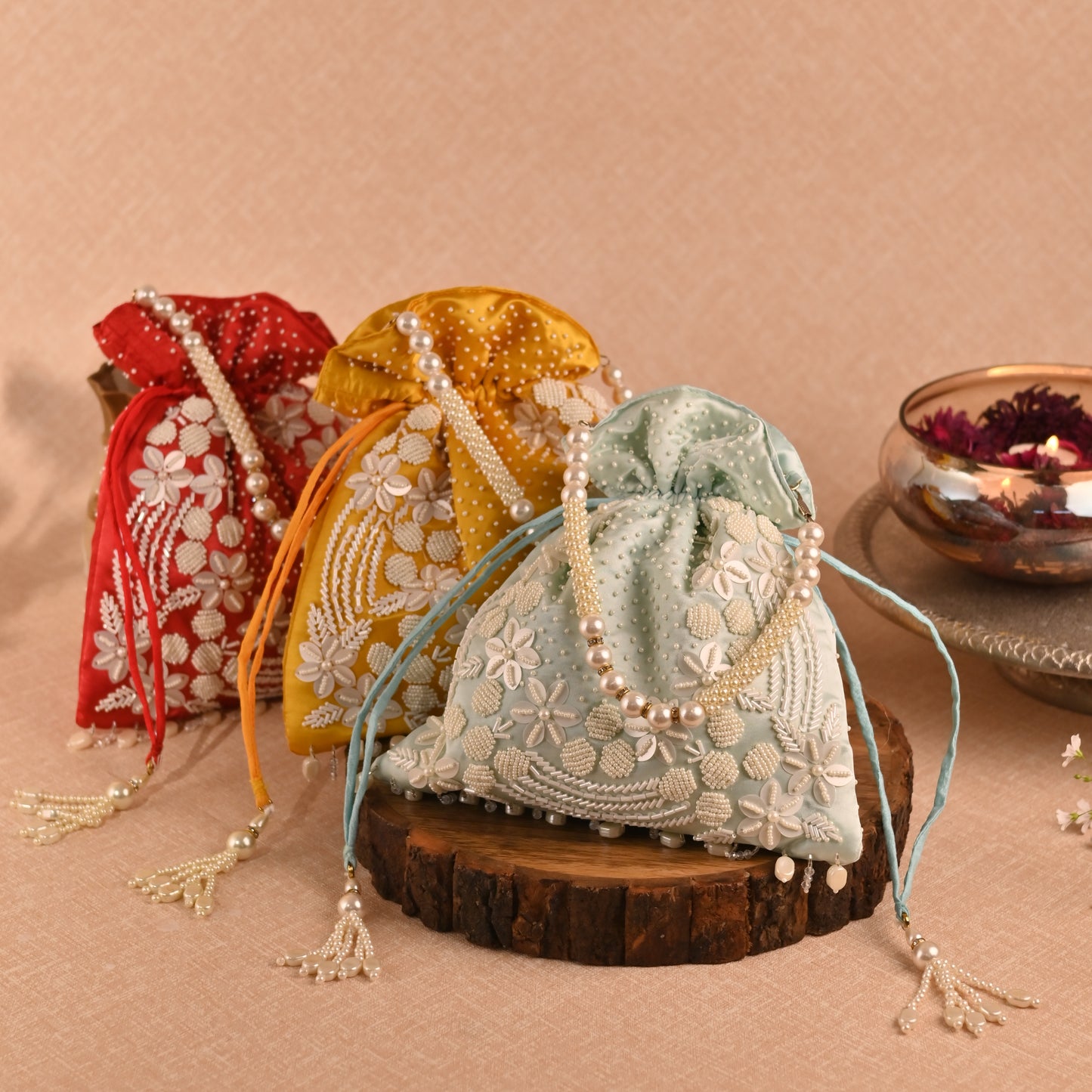 Banaavat Essence Muslin Silk Potli – White Bead & Pearl Embellished (Pastel Blue, Red & Yellow)