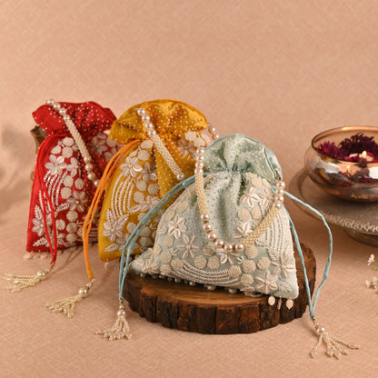 Banaavat Essence Muslin Silk Potli – White Bead & Pearl Embellished (Pastel Blue, Red & Yellow)