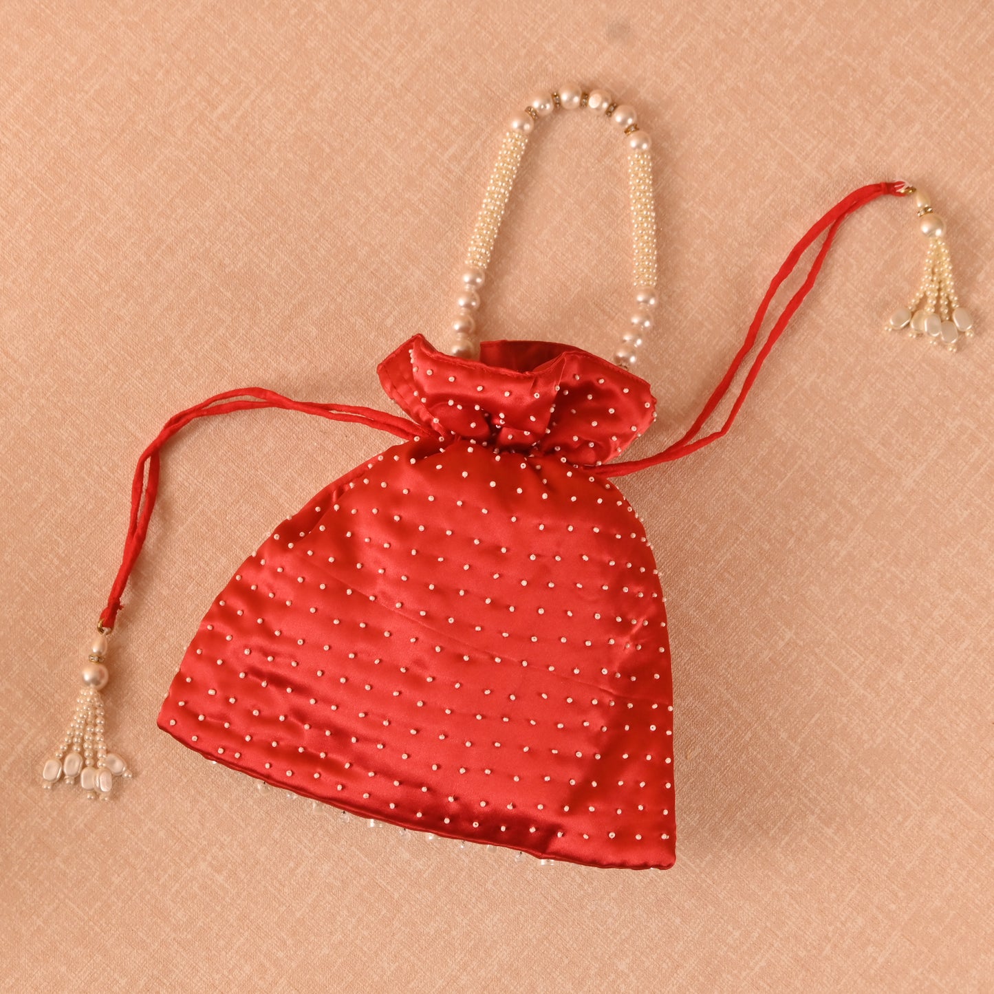 Banaavat Essence Muslin Silk Potli – White Bead & Pearl Embellished (Pastel Blue, Red & Yellow)