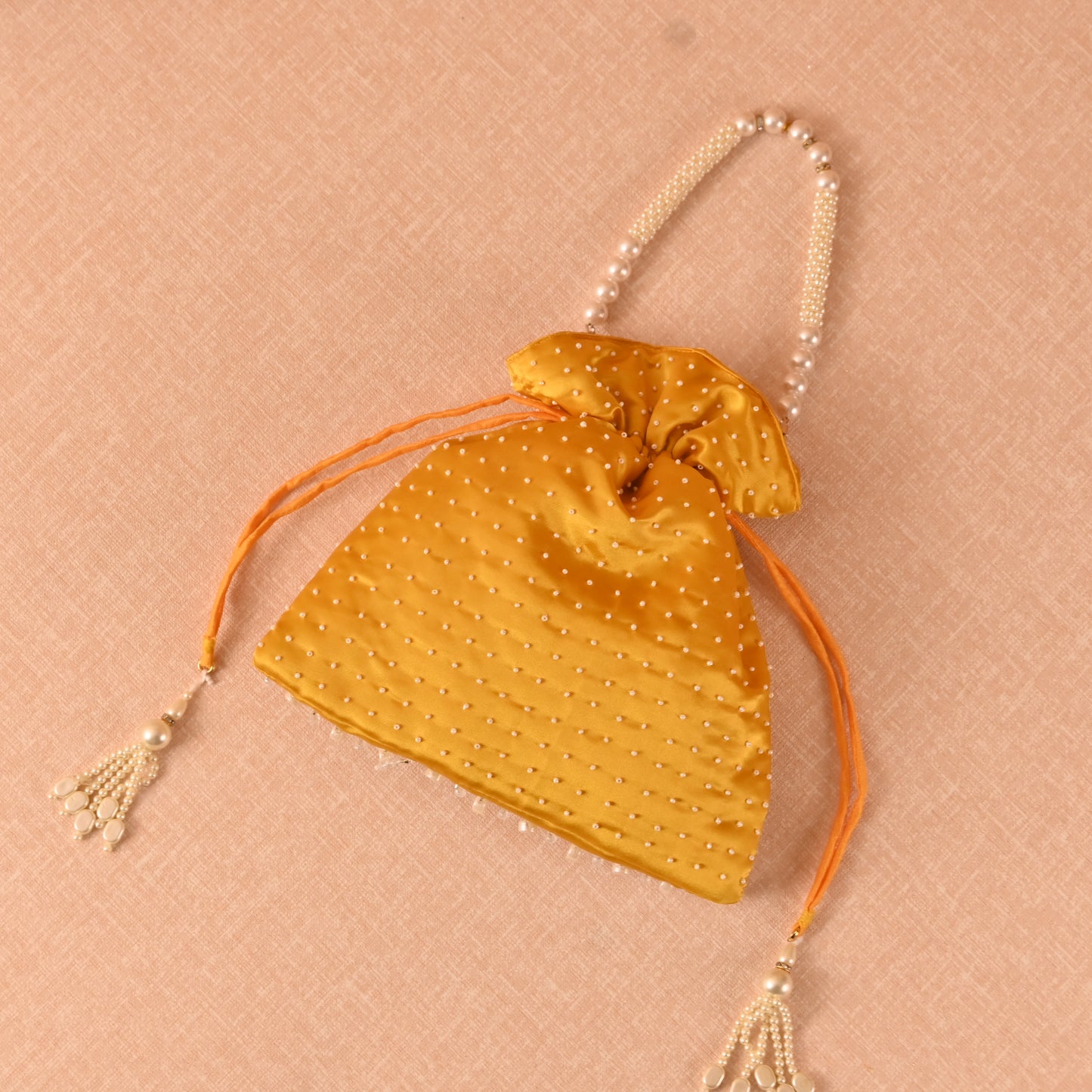 Banaavat Essence Muslin Silk Potli – White Bead & Pearl Embellished (Pastel Blue, Red & Yellow)